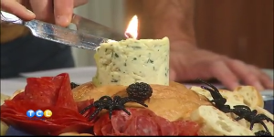 A delicious edible butter candle with roasted garlic and blue cheese, served with baguette slices.